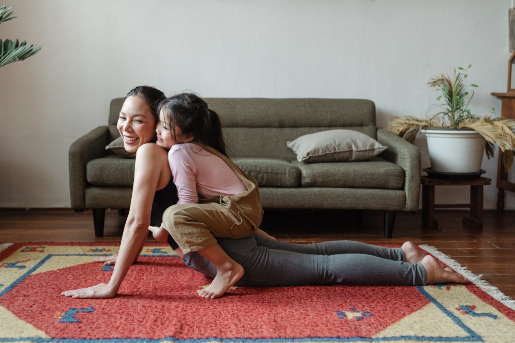 Photo of Girl Hugging Her Mom While Doing Yoga Pose Setting Boundaries for Step-Parents.
