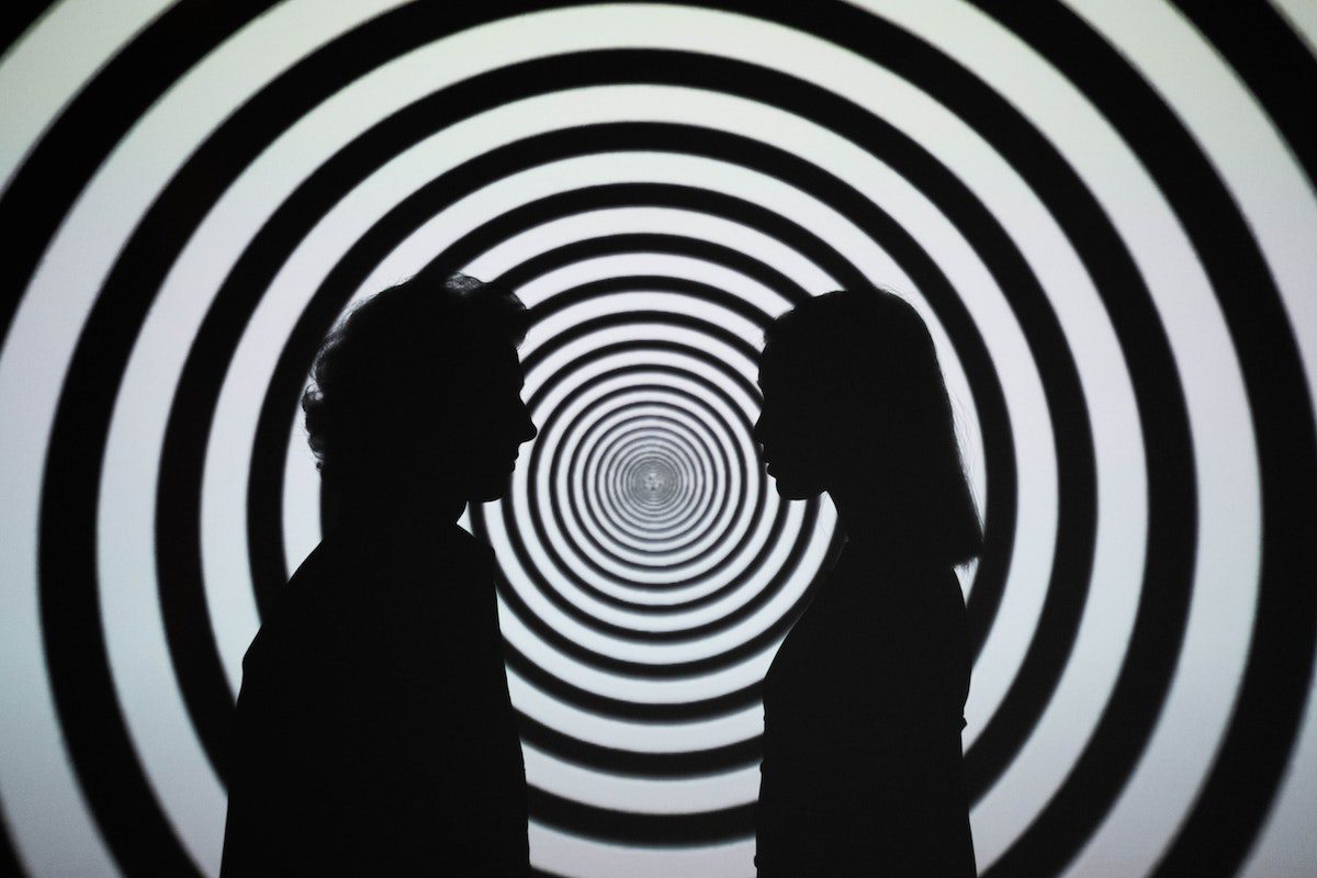 What is Hypnotherapy and How Does It Work, Silhouette of 2 Person Standing in Front of White and Black Stripe Wall